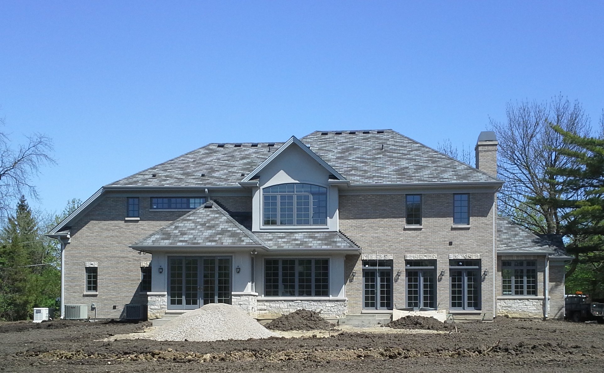 Shingled roof and stone facade on a custom North Shore home