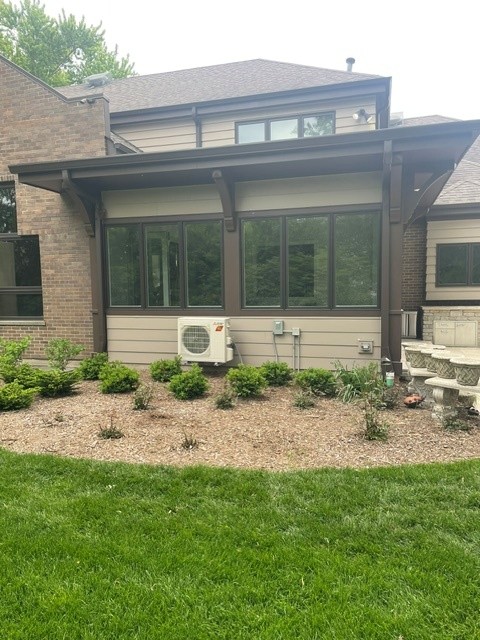 Rear home addition with timber columns and large windows