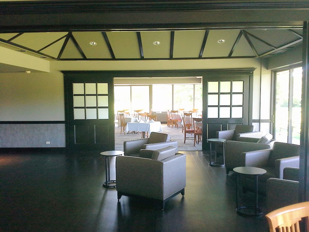 Renovated commercial lounge with seating and folding glass doors
