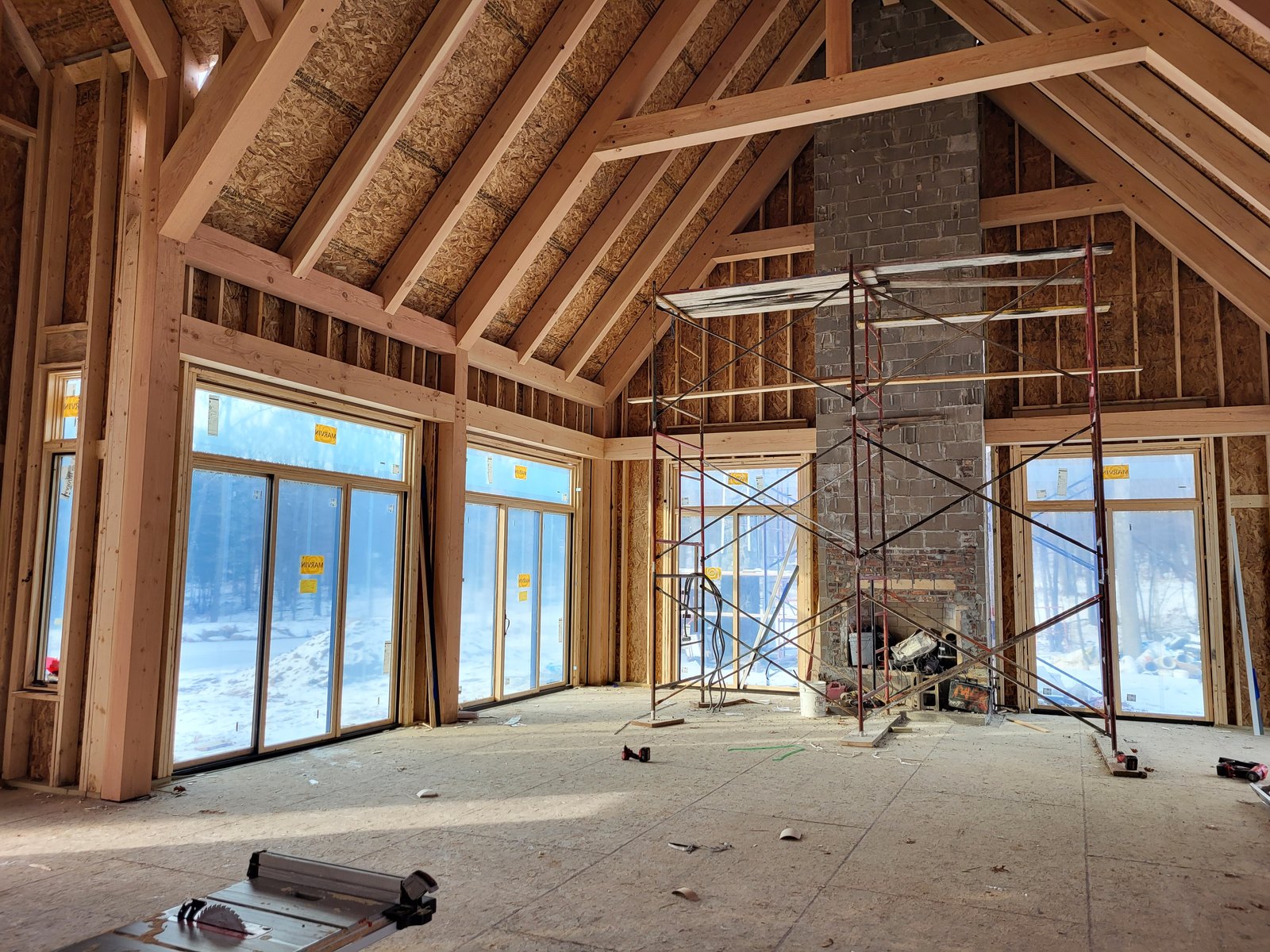 Vaulted great room under construction with exposed timber framing